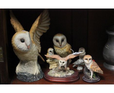 A large ceramic model of an owl, along with five other model owls 