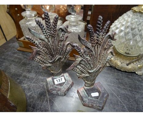 A pair of metal book end in the the form of a sheaf of wheat 