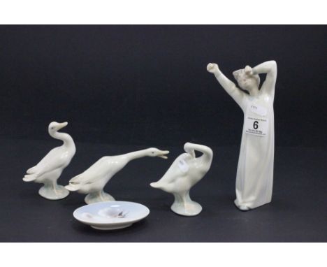 A Lladro figure of a girl, along with three lladro model ducks and a Royal Copenhagen dish