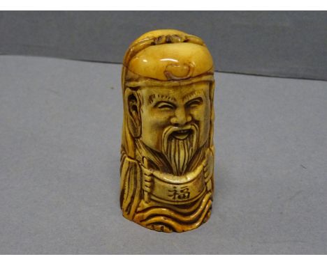 Bone netsuke of a man holding Chinese scroll