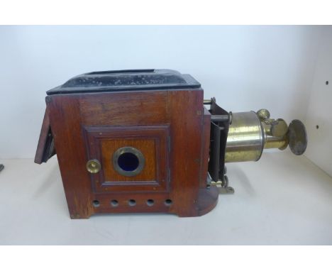 A Victorian mahogany and brass projector with four wick burner, missing chimney, 28cm tall x 45cm long 