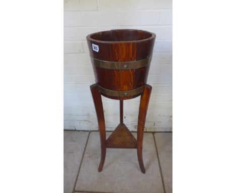 An oak planter with brass banding, by R Alister and Co Ltd, 92cm tall, 26cm diameter 