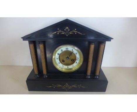 A French black slate clock, runs but stops - 29cm tall 