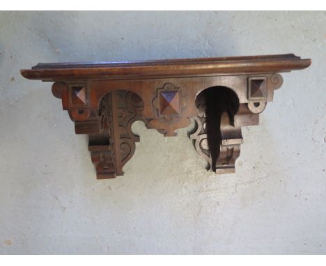 An oak Gothic wall bracket shelf, 25cm tall x 43cm x 27cm 