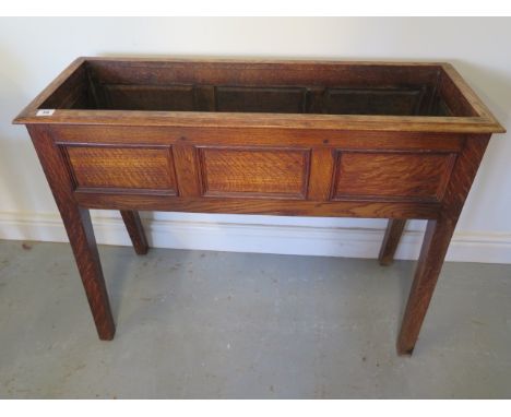 An oak planter with three panel front, 72cm tall x 95cm x 34cm 
