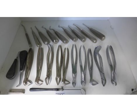 A collection of 20th century dental tools including extraction forceps, probes, mirror, makers include Friedman Spec Co, Down
