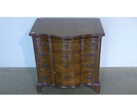 An 18th/19th century walnut serpentine fronted bachelor chest with a slide above four leather banded drawers on bracket feet 