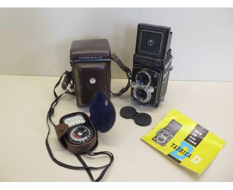 A Yashica - D twin lens camera with leather case and booklet, shutter working and a Weston Master II light meter 