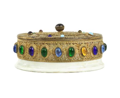 A Persian gilt metal oval trinket box, early 20th century. With glass stones, the ceramic base with calligraphy, height 5cm, 
