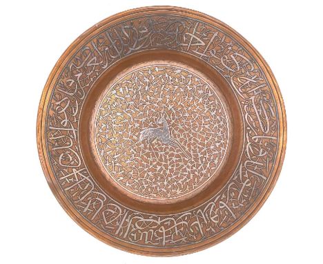 A Mamluk revival copper and silver inlaid bowl, Egypt, circa 1900.  The centre decorated with a leaping deer amongst tendrils