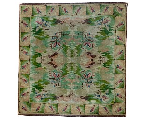 An Art Deco chenille rug, circa 1930's. The polychrome field with abstract designs and floral sprays, within a rectangular pa
