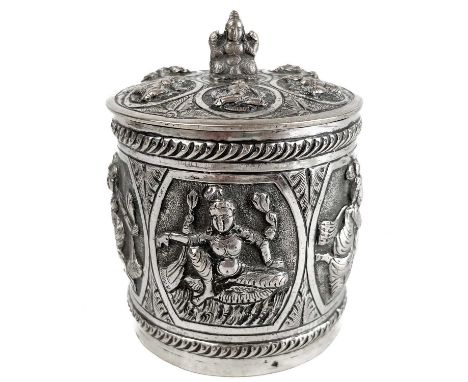 A 19th century Indian Swami silver cylindrical tea caddy. Repousse decorated with reserves of Hindu immortals, height 9.5cm, 