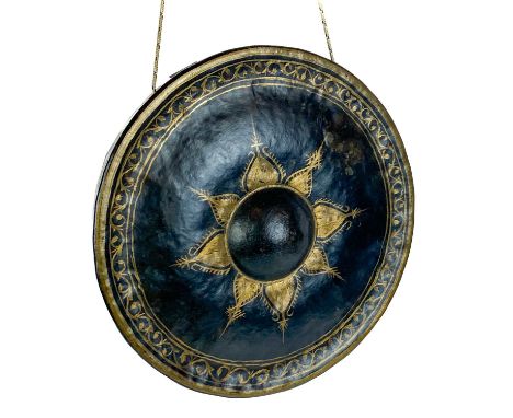 An Anglo Indian bronze and gilt decorated gong, early 20th century. With part paper label entitled 'British Empire Exhibition
