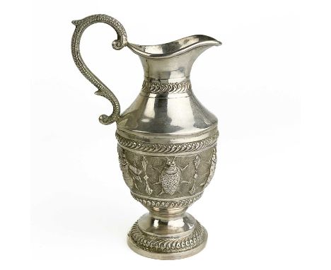 An Indian silver pedestal cream jug. Embossed with a band of beetles and with fluted banding, height 13cm, 116.3g.