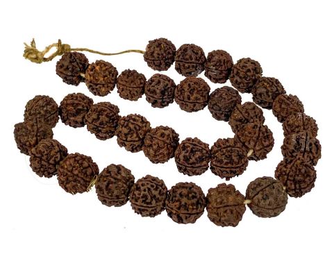 An Indian thirty-two rudraksha bead necklace. Length 32cm.The West Cornwall vendor inherited the necklace from her Indian fat