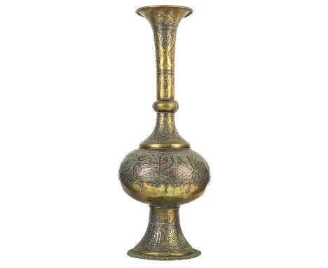 A Cairoware brass and silver inlaid vase, Egypt, circa 1900.  With a flared rim and tapering neck above a bulbous body with a