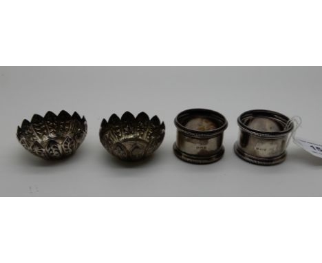 A lot comprising a pair of silver salts, Glasgow 1895 and a pair of silver napkin rings, Birmingham 1918, 81gms Condition Rep