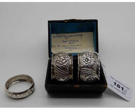 A lot comprising a cased pair of silver napkin rings, Birmingham 1915 and a single napkin ring, Birmingham 1938 (3) 66gms Con