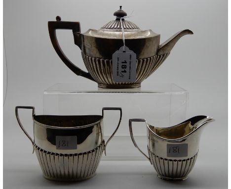 A lot comprising a bachelor's silver teapot, Sheffield 1885 and a silver cream and sugar, London and Birmingham marks, 436gms