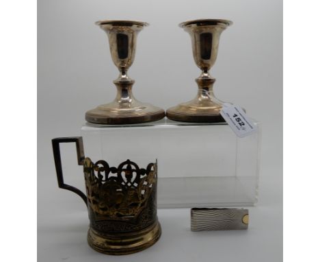 A lot comprising a pair of silver candlesticks, Sheffield 1792, a sterling silver money clip and a silver neillo cup holder (