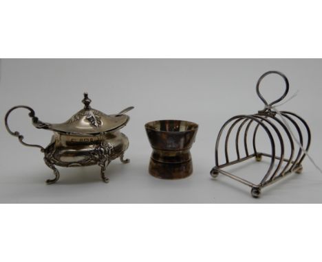 A lot comprising a silver toastrack, Birmingham 1909, a mustard pot, Birmingham 1900 and an egg stand, London 1813 (3), 177gm