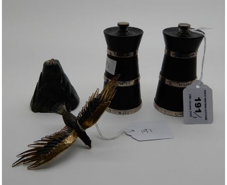 A lot comprising a near pair of silver banded ebonised loop pepper mills, Birmingham 1937 and 1939 and a silver gilt and enam
