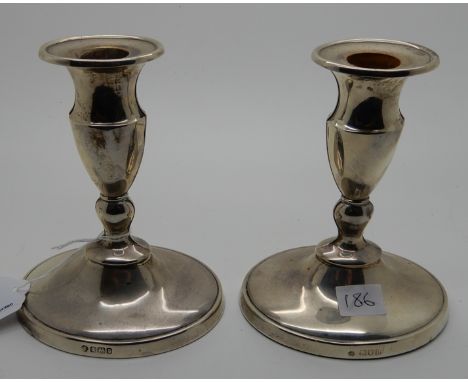 A pair of silver candlesticks, Sheffield 1909, 14cm high, weighted Condition Report: Available upon request