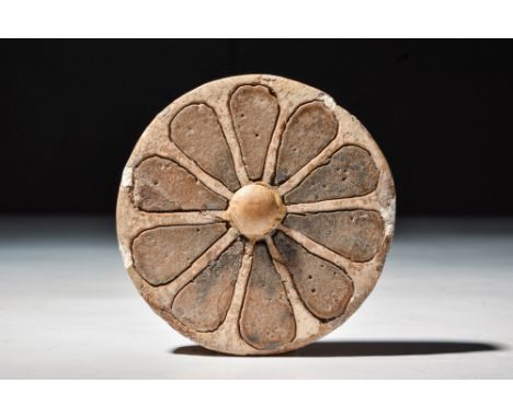 New Kingdom, 20th Dynasty, Ca. 1184 - 1153 BC.
A glazed composition inlay in the form of a rosette, set with creamy brown pet