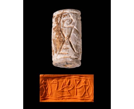 Early Dynastic Period, Ca. 3150 - 2686 BC.
A bone cylindrical stamp seal carved with an intriguing scene incised across the e