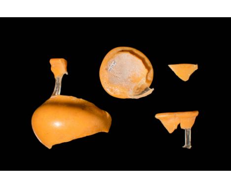 New Kingdom, Ca. 1550-1070 BC.
Fragments of a vibrant yellow glass vase in the form of a pomegranate with elongated shape and