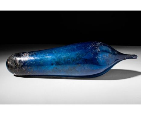 Ca. 100 BC - AD 100.
A blue glass pointed unguentarium. The elongated pyriform body shrinks downward to close at a point at t