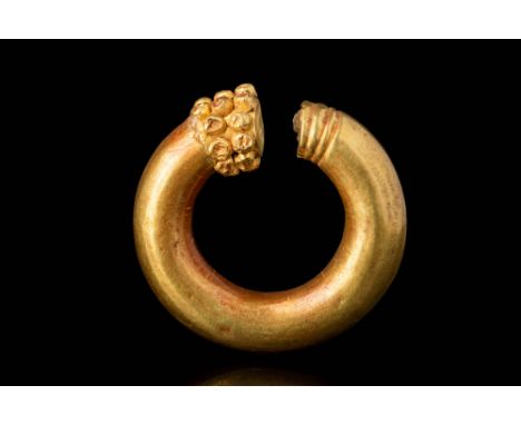 Ca. 400 - 100 BC.An exquisite gold earring featuring a penannular shape enriched by clusters of gold granules. This form of e