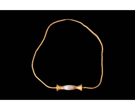 Ca. 2300 - 1800 BC.A gorgeous 22.5 ct wearable necklace composed of a barrel shaped agate bead with gold terminals, set in an