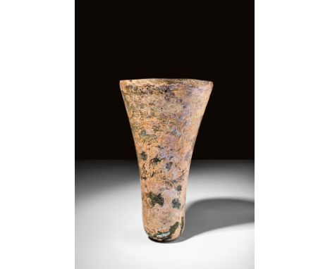 Ca. AD 1300 - 1500.
A finely preserved example of a decorative beaker, free-blown and with a narrow body that flares outward 