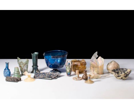 Ca. AD 100 - 300.
A large group of glassware comprising a collection of 17 pieces, including sandcore amphorae, ribbed bowls,