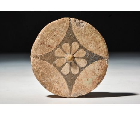 New Kingdom, 20th Dynasty, Ca. 1184 - 1153 BC.
A glazed composition inlay in the form of a rosette, set with an X-shaped desi