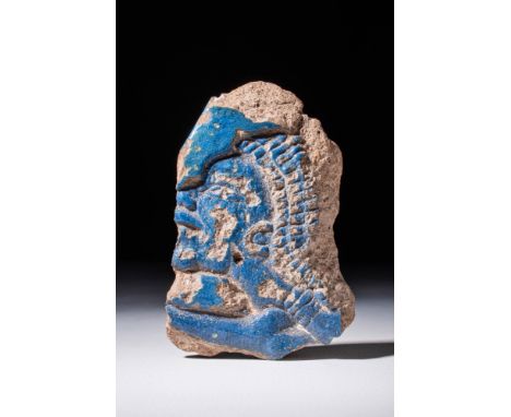 New Kingdom, Ca. 1550 - 1069 BC.
A decorated fragment of faience in shallow relief in one register, with friezes showing a da