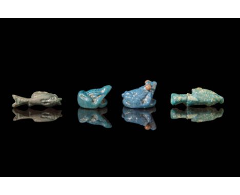 Late Period, Ca. 664 - 332 BC.A collection of four faience amulets comprising two fish-shaped amulets covered with green homo