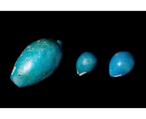 Middle Kingdom, Ca. 2055 - 1773 BC .A group of three hollow, vibrant, blue glazed faience egg-shaped balls. These balls are p