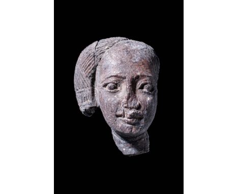 New Kingdom, Ca. 1550 - 1069 BC.
A rare and slender wooden carving head of Harpocrates or a youth. The finely detailed portra