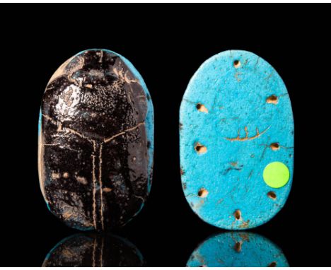 New Kingdom, Ca. 1550 - 1069 BC.
A stunning funerary scarab made of two coloured Maiolica. The top displays characteristic in