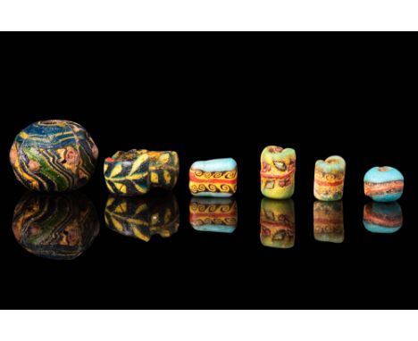 Ca. 30 BC - AD 200.
A set of six mosaic glass beads, comprising various shapes, including cylindrical, spherical, biconical, 