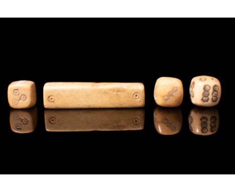 Ca. AD 100 - 300. A set of bone gambling dice comprising three square-shaped dice with engraved dots/circles and an elongated