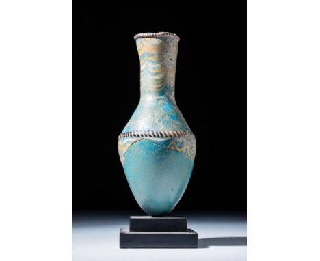 New Kingdom, Ca. 1550 - 1069 BC.
A tall bottle made from green/blue glass, its elegant silhouette exhibits a rounded shoulder