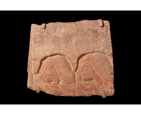 Amarna Period, Ca. 1353 - 1336 BC.
A relief fragment carved from pale orange sandstone. On the right, it depicts the heads of