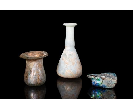 Ca. AD 100 - 300.A beautiful group of three petite, free-blown glass unguentaria from the Roman period in yellow-green and wh