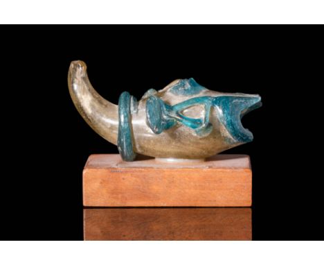 Ca. AD 600 - 800.
A remarkable glass flask crafted in the shape of a fish using a mould. The vessel's exterior is adorned wit