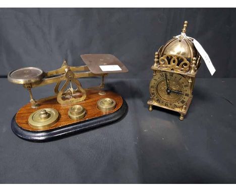 BRASS MINIATURE LANTERN-TYPE CLOCKalong with a set of brass and wood postal scales with weights