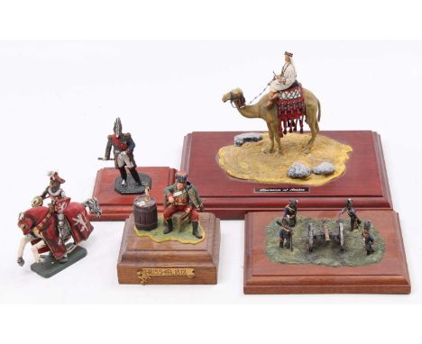 A collection of mixed scale white metal and hand painted military figurines to include Laurence of Arabia, an 1812 Hussar, an