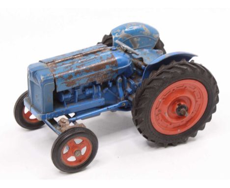 A Chad Valley diecast and clockwork model of a Fordson Super Major Tractor, comprising blue body with orange hubs, play-worn